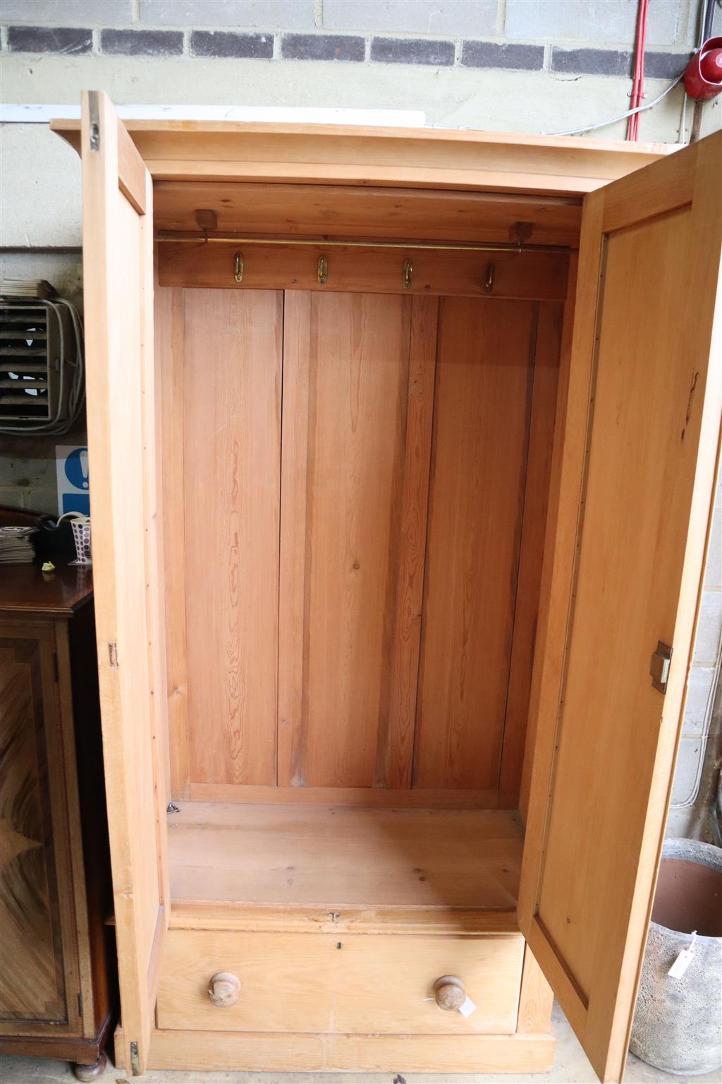 A late Victorian pine wardrobe, width 115cm, depth 51cm, height 215cm